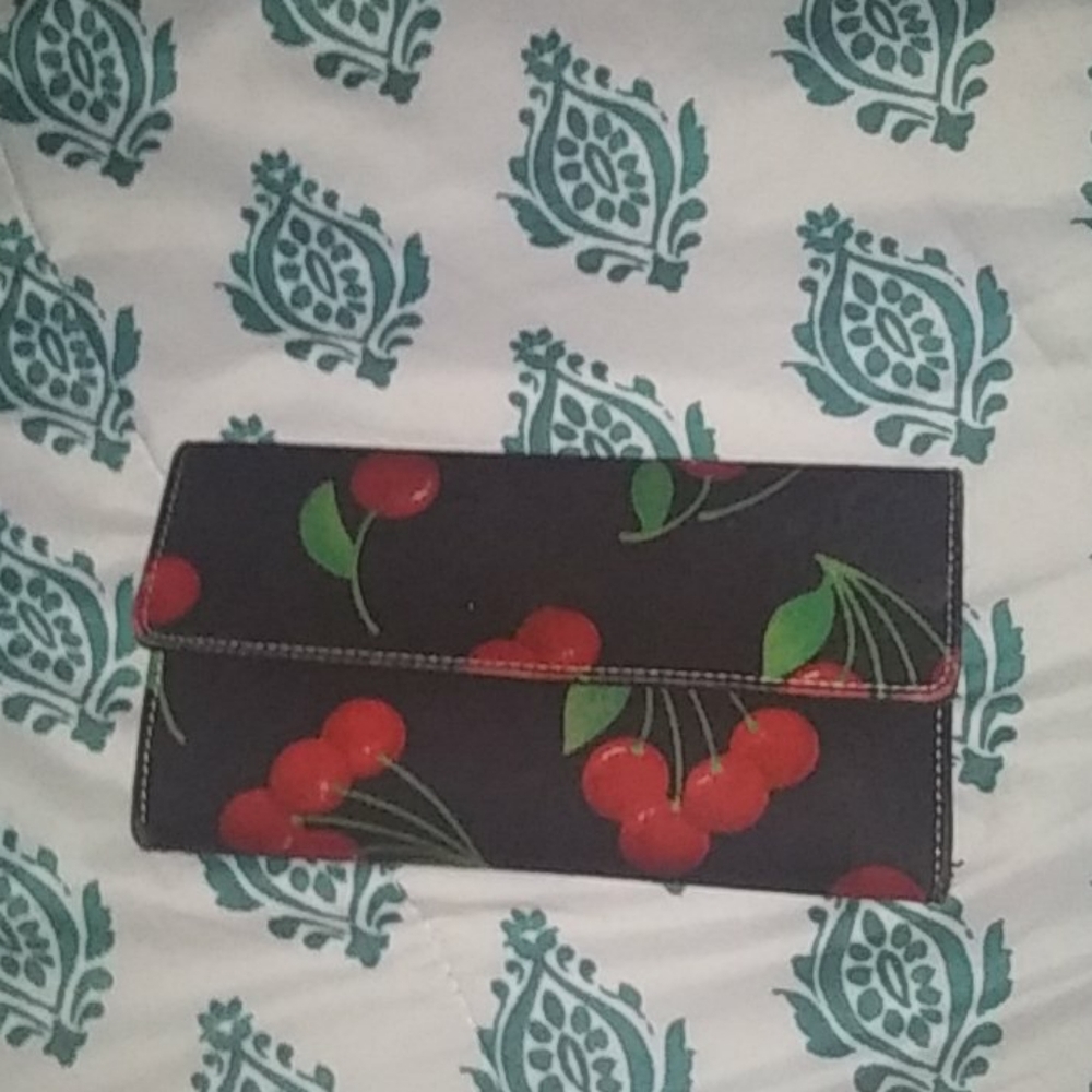 A black wallet with cherries on it